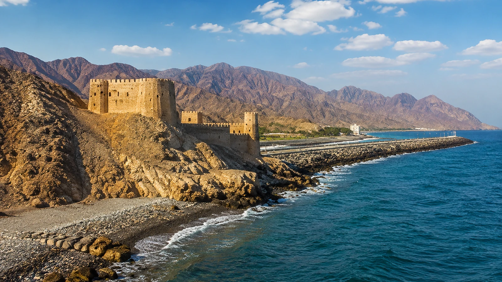Private group transport travelling through the Hajar Mountains on a planned Fujairah East Coast route.