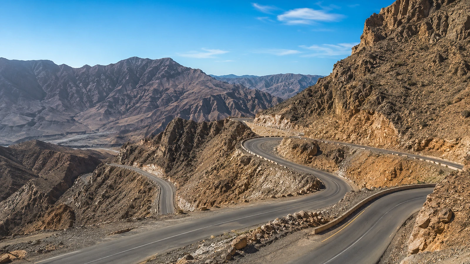 Private Ras Al Khaimah sightseeing vehicle near heritage and mountain landscapes.